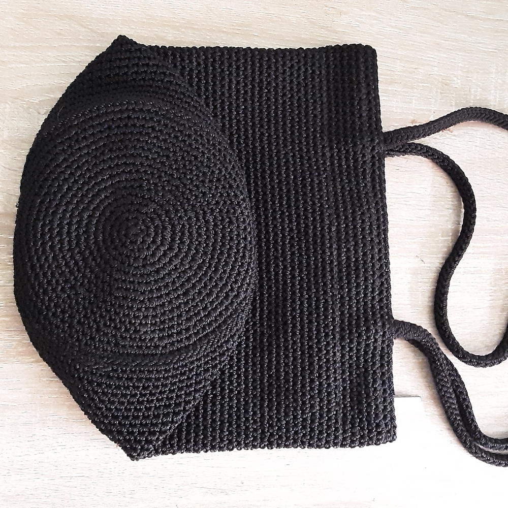 Black Woven Straw Bucket Bag with Round Flap Brand The Sak.